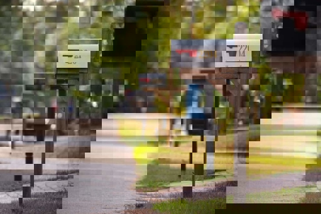 A row of mailboxes on a suburban street.