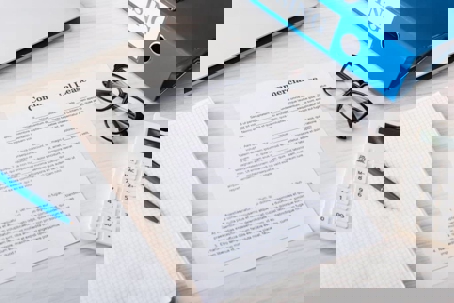 Commercial lease document surrounded by office supplies.